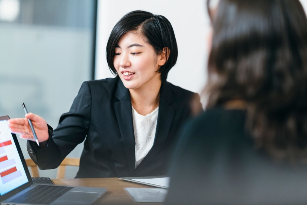 Japanese business consultant is giving advice to her client at home